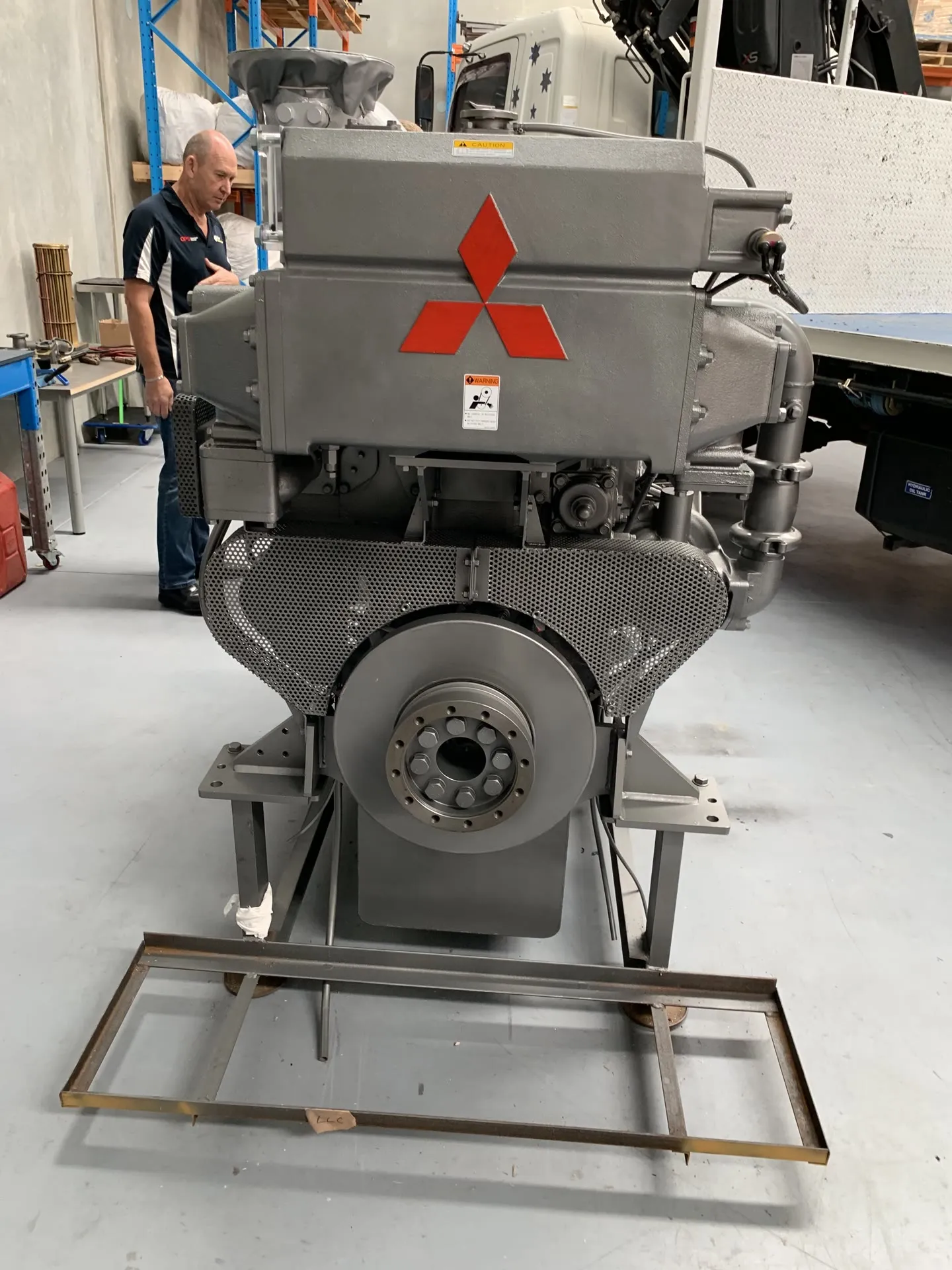 An S6R2-MPTK marine engine on a fabrication stand in OPS's Wangara warehouse, nameplate visible
